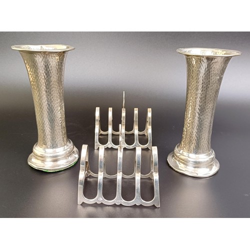 163 - A pair of George V silver four section toast racks, 2.1 ozt, and a pair of silver vases, bases fille... 