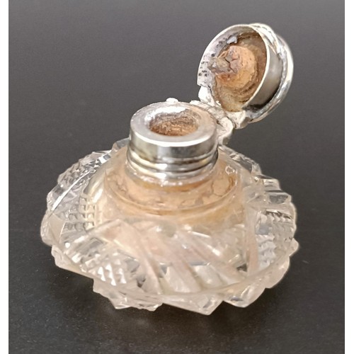 203 - A miniature cut glass scent bottle, with a silver mount, 3.5 cm diameter