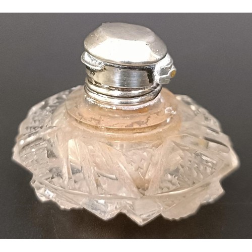 203 - A miniature cut glass scent bottle, with a silver mount, 3.5 cm diameter