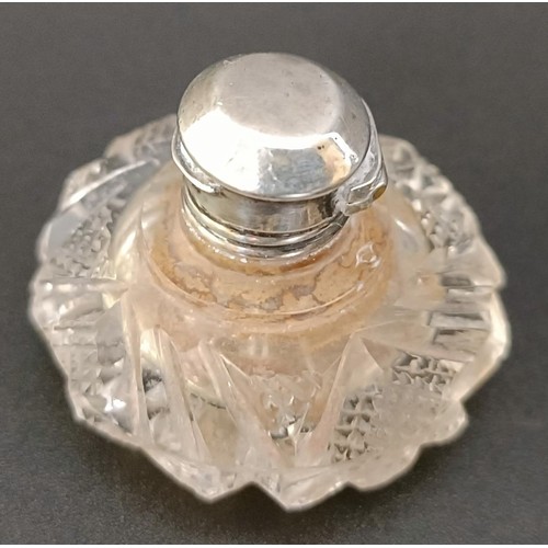 203 - A miniature cut glass scent bottle, with a silver mount, 3.5 cm diameter