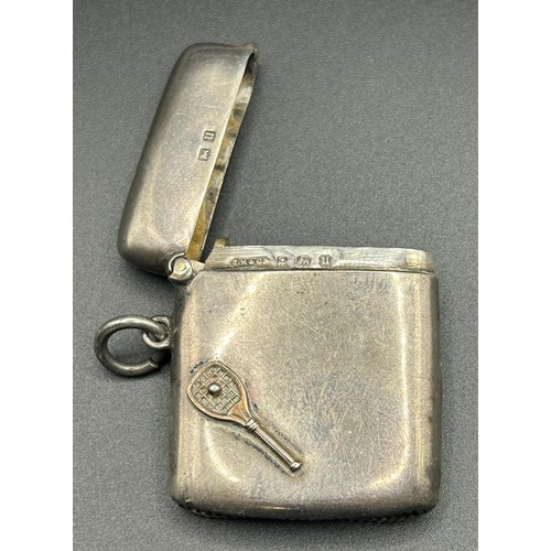 212 - A George V silver vesta case, applied a tennis racket and ball, Birmingham 1919, 24.5 g, 4.5 cm high