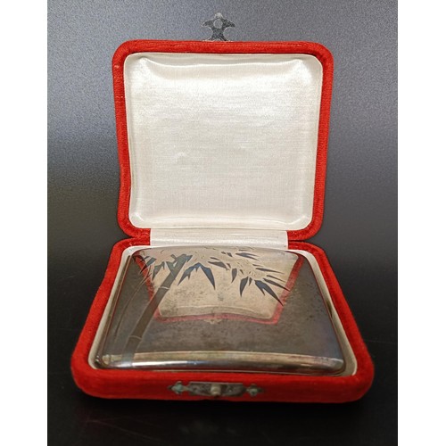 377 - An Eastern silver coloured metal cigarette case, cased