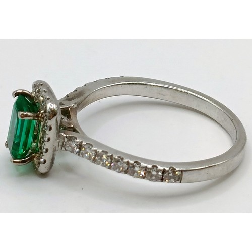 617 - An 18ct white gold, diamond and emerald cluster ring, ring size J