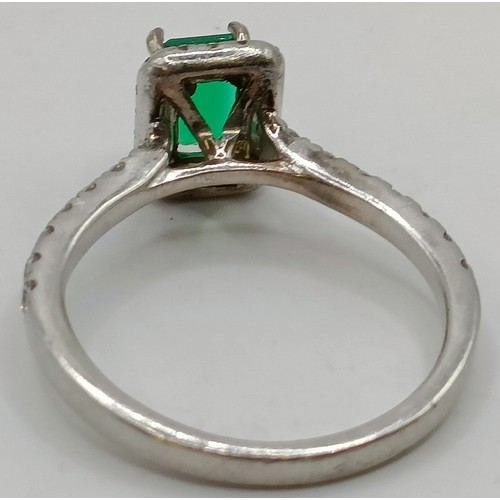 617 - An 18ct white gold, diamond and emerald cluster ring, ring size J