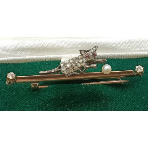 633 - An early 20th century yellow metal, diamond and pearl stick pin, in the form of a cat playing with a... 