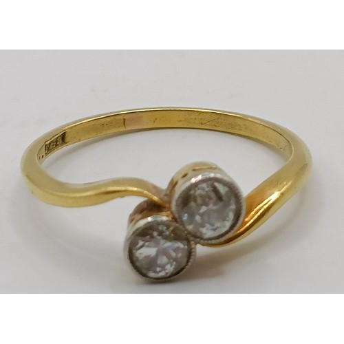 650 - An 18ct gold and diamond cross over ring, ring size K Provenance:  Sold on behalf of Dorset Wildlife... 