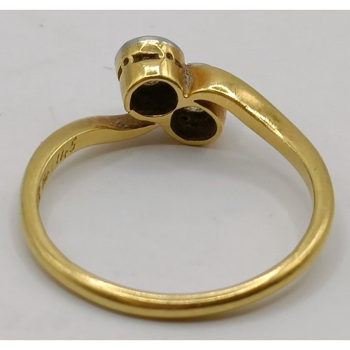 650 - An 18ct gold and diamond cross over ring, ring size K Provenance:  Sold on behalf of Dorset Wildlife... 