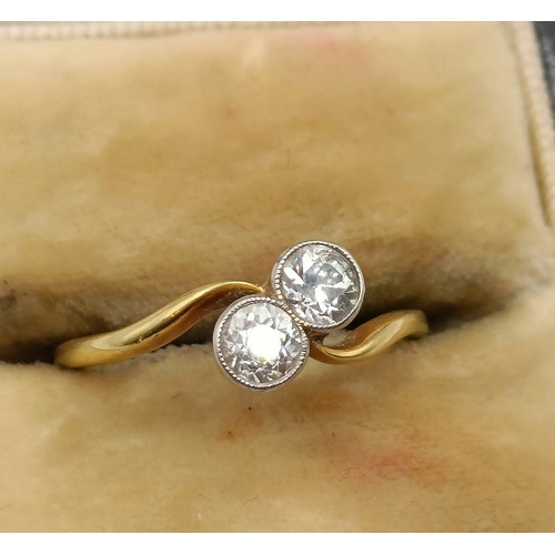 650 - An 18ct gold and diamond cross over ring, ring size K Provenance:  Sold on behalf of Dorset Wildlife... 