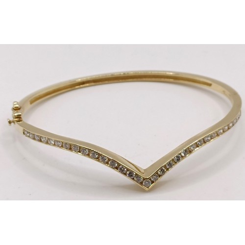 652 - An 18ct gold and diamond wishbone bangle, 11.6 g (all in)