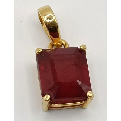 663 - An 18ct gold and ruby pendant