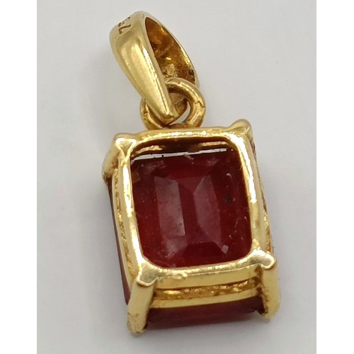 663 - An 18ct gold and ruby pendant