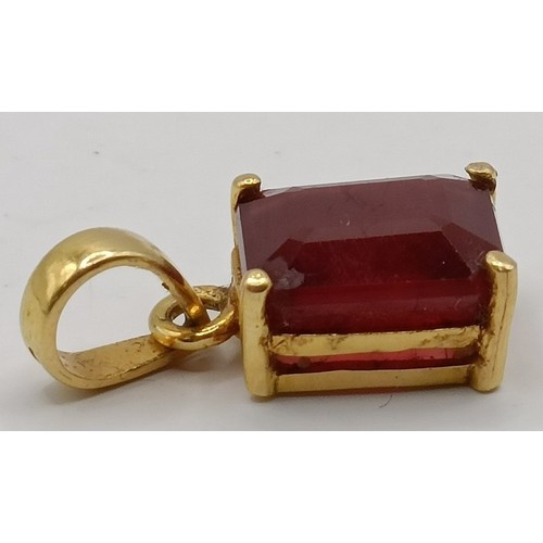 663 - An 18ct gold and ruby pendant