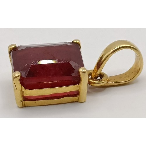 663 - An 18ct gold and ruby pendant