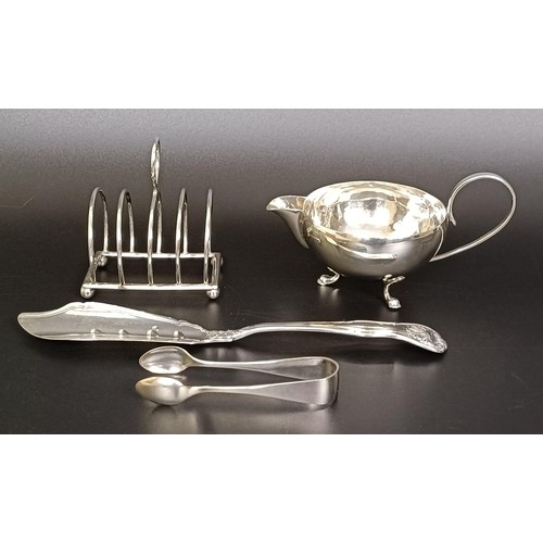 263 - A George V cream jug, a four section silver toast rack, a pair of sugar nips and a fish knife, vario... 