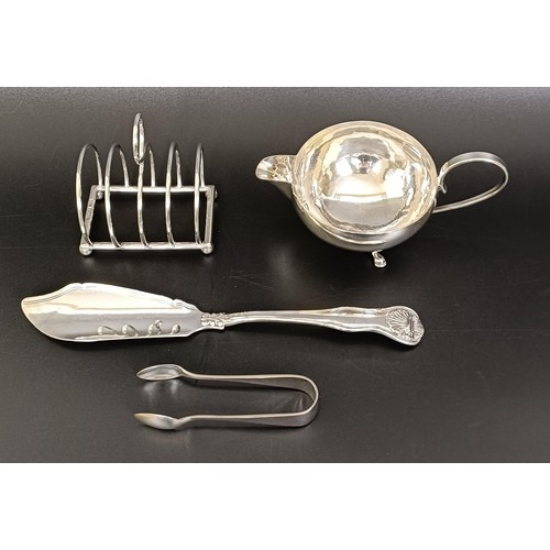 263 - A George V cream jug, a four section silver toast rack, a pair of sugar nips and a fish knife, vario... 