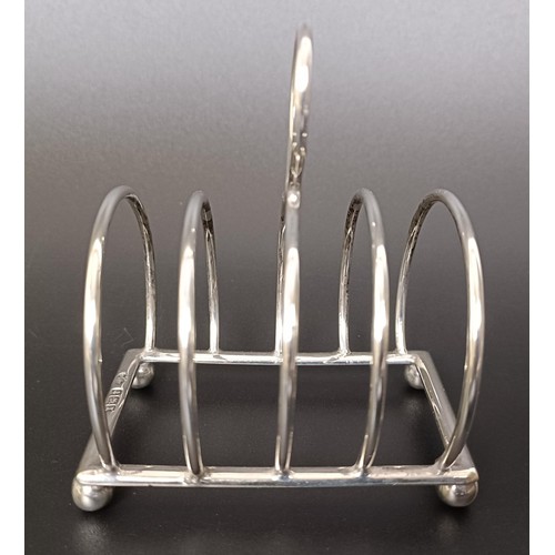 263 - A George V cream jug, a four section silver toast rack, a pair of sugar nips and a fish knife, vario... 