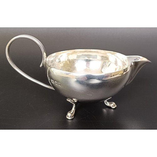 263 - A George V cream jug, a four section silver toast rack, a pair of sugar nips and a fish knife, vario... 