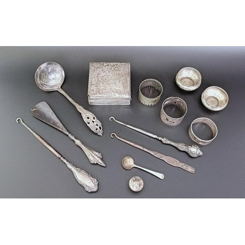 266 - A George V silver box, with a wooden lining, three napkin rings, a ladle, and assorted other items