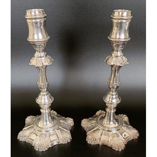 397 - A pair of Georgian style candlesticks, with shell design, Birmingham 1964, 51.3 ozt (all in), 23 cm ... 