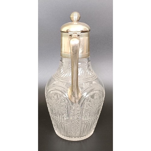 408 - An Austrian cut glass claret jug, with silver mount and handle, 25 cm high