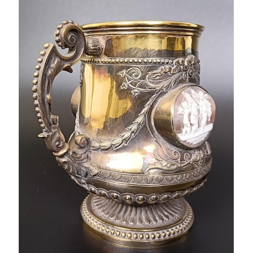 409 - An unusual Victorian silver gilt mug, inset with two carved cameos decorated classical scenes, Londo... 