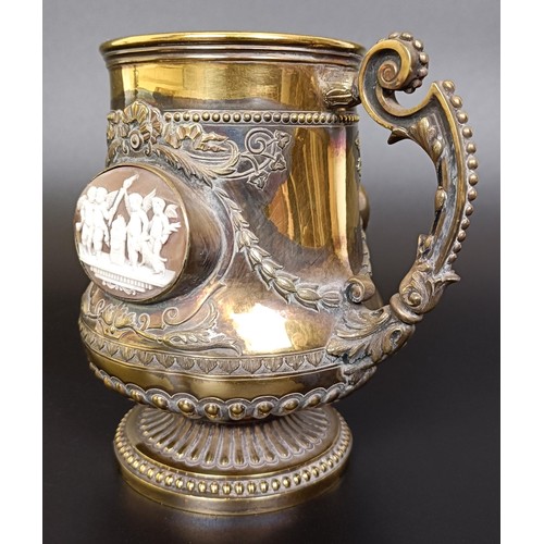 409 - An unusual Victorian silver gilt mug, inset with two carved cameos decorated classical scenes, Londo... 