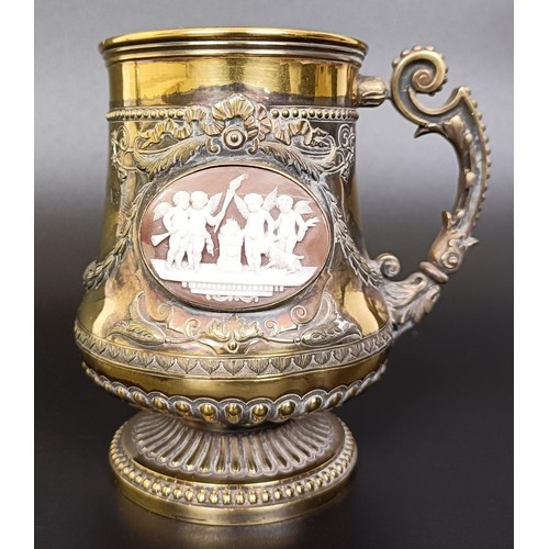 409 - An unusual Victorian silver gilt mug, inset with two carved cameos decorated classical scenes, Londo... 