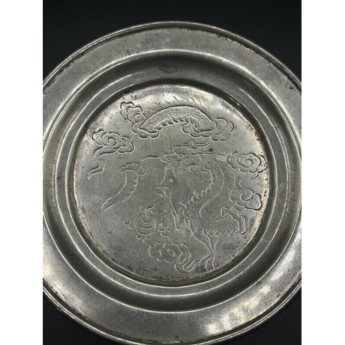 282 - A Chinese silver coloured metal teapot stand, decorated a dragon, 3.9 ozt, 11.5 cm diameter