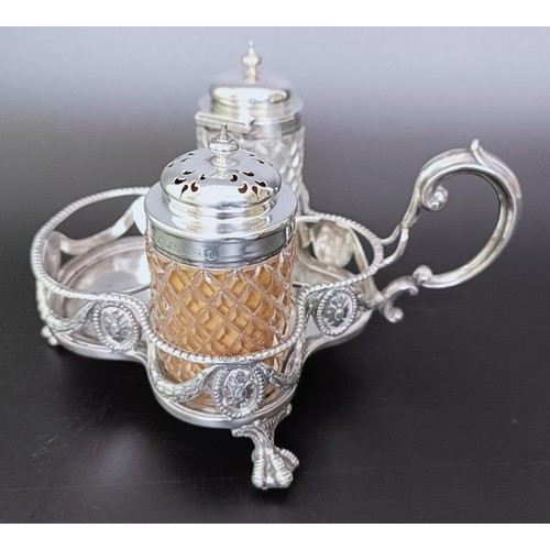 310 - A Victorian silver cruet stand, London 1894, 6.53 ozt, and two silver mounted condiment jars (3)