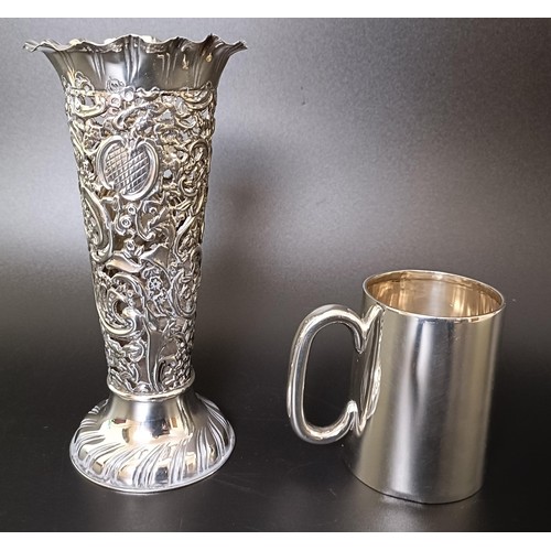 312 - A George V silver mug, and a pierced silver posy vase, 7.1 ozt (2)