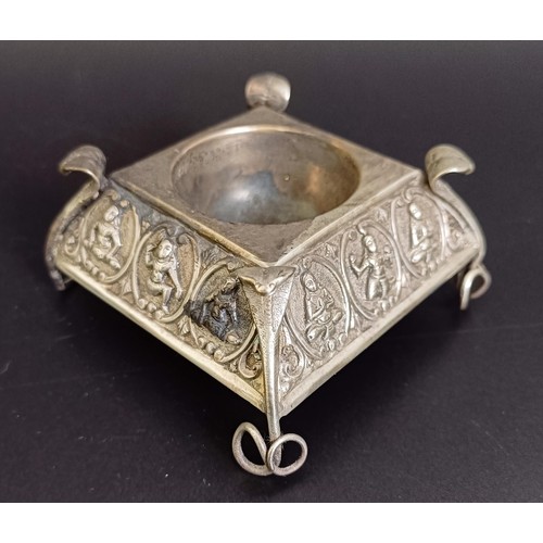 313 - An Eastern silver coloured metal ashtray, a snuff box, a matchbox holder, and another ashtray (4)