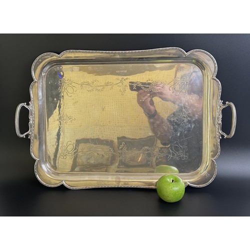 18 - A George VI silver twin handled tray, with engraved decoration of flowers and foliage, Sheffield 193... 