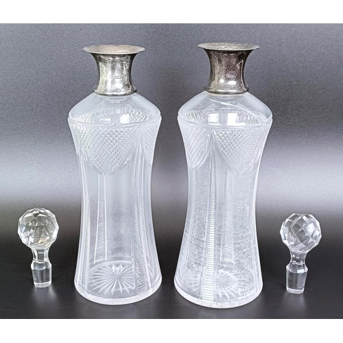 402 - A pair of George V glass decanters, with silver mounts, Sheffield 1934, 31 cm high (2)