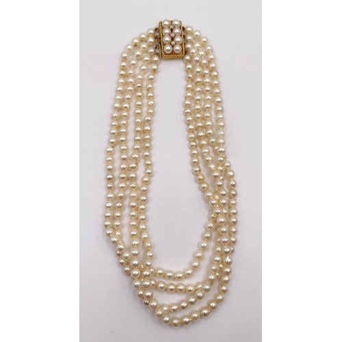 744 - A quadruple strand pearl necklace, with a 9ct gold clasp