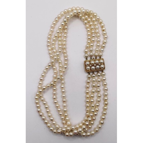 744 - A quadruple strand pearl necklace, with a 9ct gold clasp