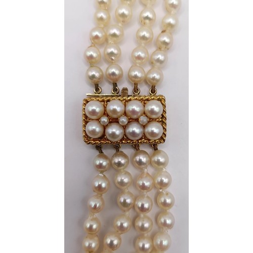 744 - A quadruple strand pearl necklace, with a 9ct gold clasp