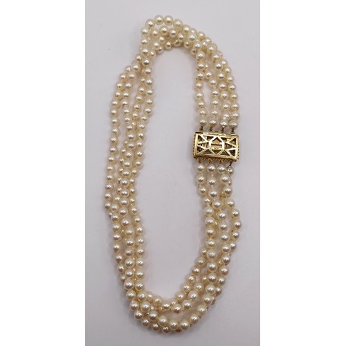 744 - A quadruple strand pearl necklace, with a 9ct gold clasp