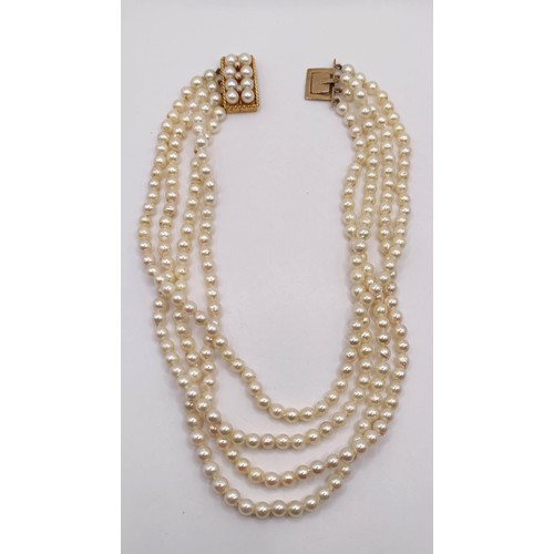 744 - A quadruple strand pearl necklace, with a 9ct gold clasp