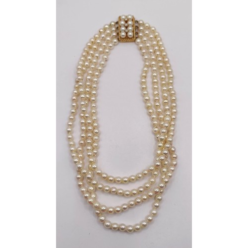 744 - A quadruple strand pearl necklace, with a 9ct gold clasp