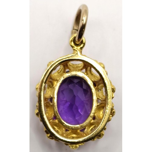 748 - An amethyst and yellow metal pendant