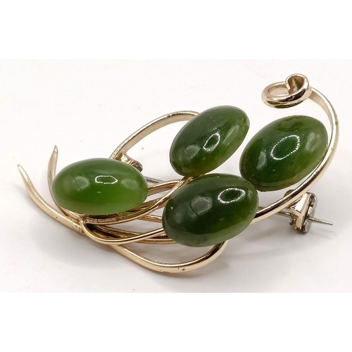 762 - A gold plated and green stone brooch