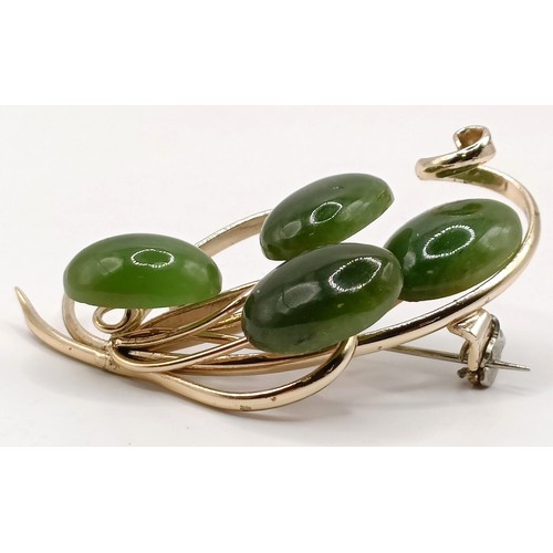 762 - A gold plated and green stone brooch