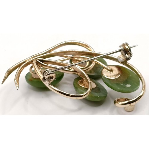 762 - A gold plated and green stone brooch