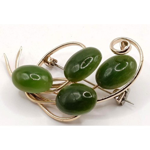 762 - A gold plated and green stone brooch