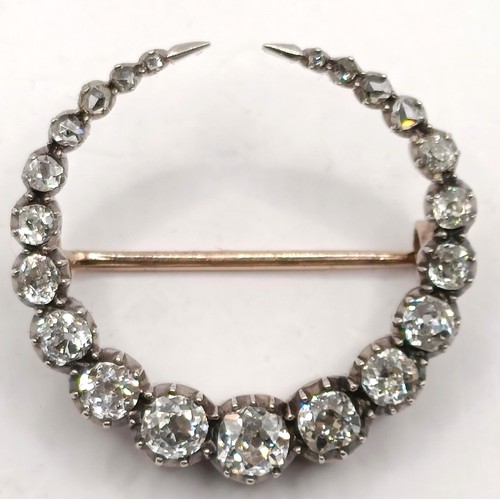 743 - An early 20th century diamond crescent brooch, in a vintage jewellery box, retail mark for Skinner o... 