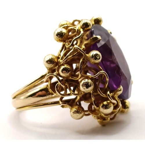 745 - A 20th century 9ct gold and amethyst ring, in an abstract setting, ring size J