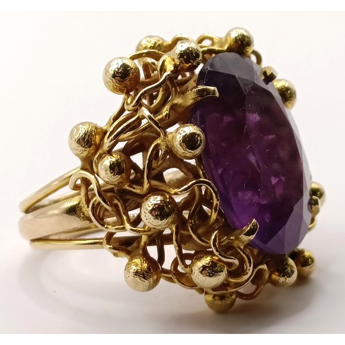 745 - A 20th century 9ct gold and amethyst ring, in an abstract setting, ring size J