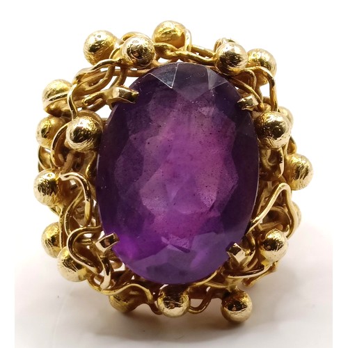 745 - A 20th century 9ct gold and amethyst ring, in an abstract setting, ring size J