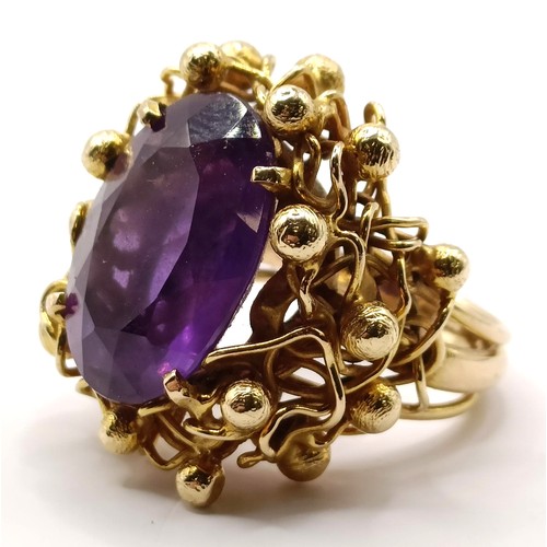 745 - A 20th century 9ct gold and amethyst ring, in an abstract setting, ring size J