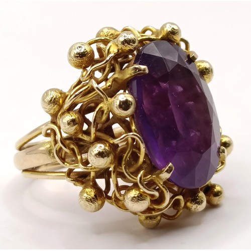 745 - A 20th century 9ct gold and amethyst ring, in an abstract setting, ring size J